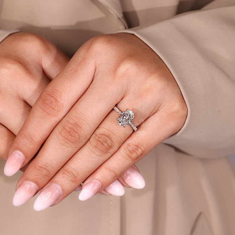 Oval cut diamond ring four claw hidden halo style.
