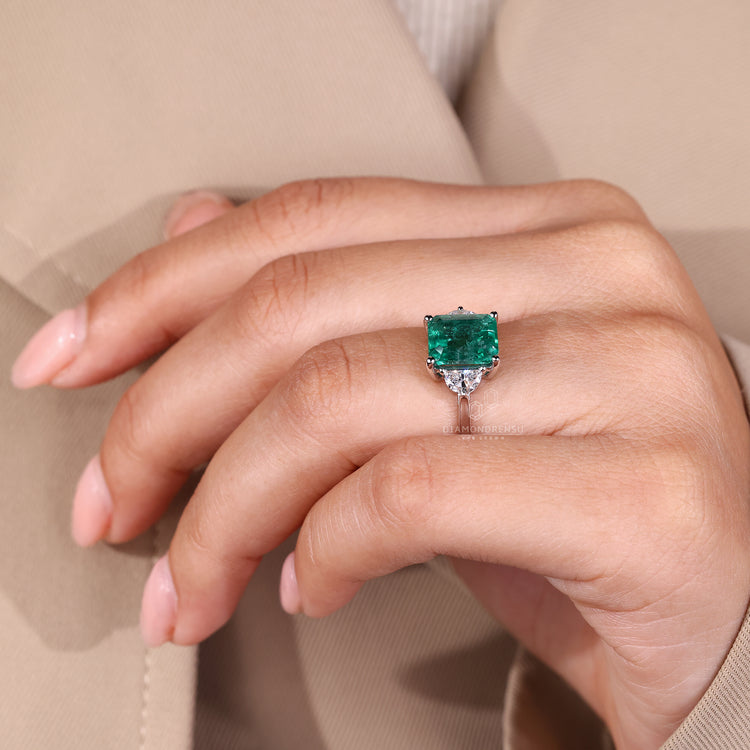 Emerald gemstone ring cathedral three stone style.
