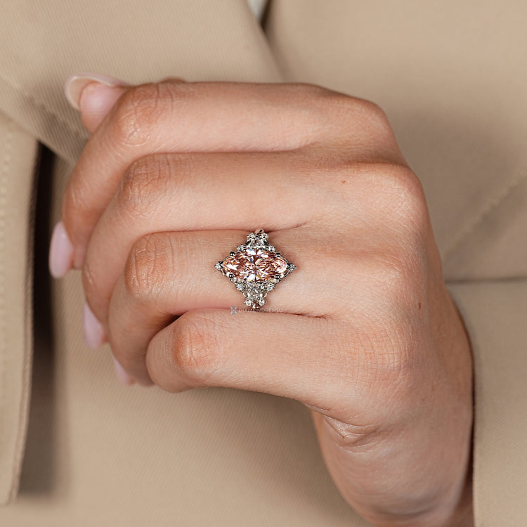 Marquise diamond ring with vintage cluster design.