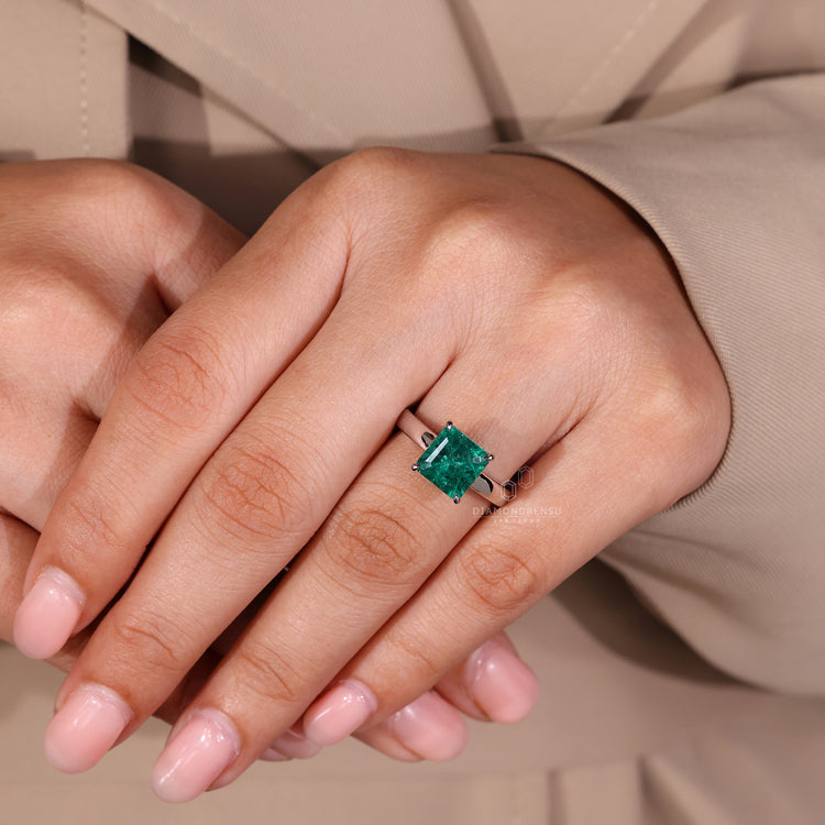Emerald gemstone ring solitaire cathedral prong set.
