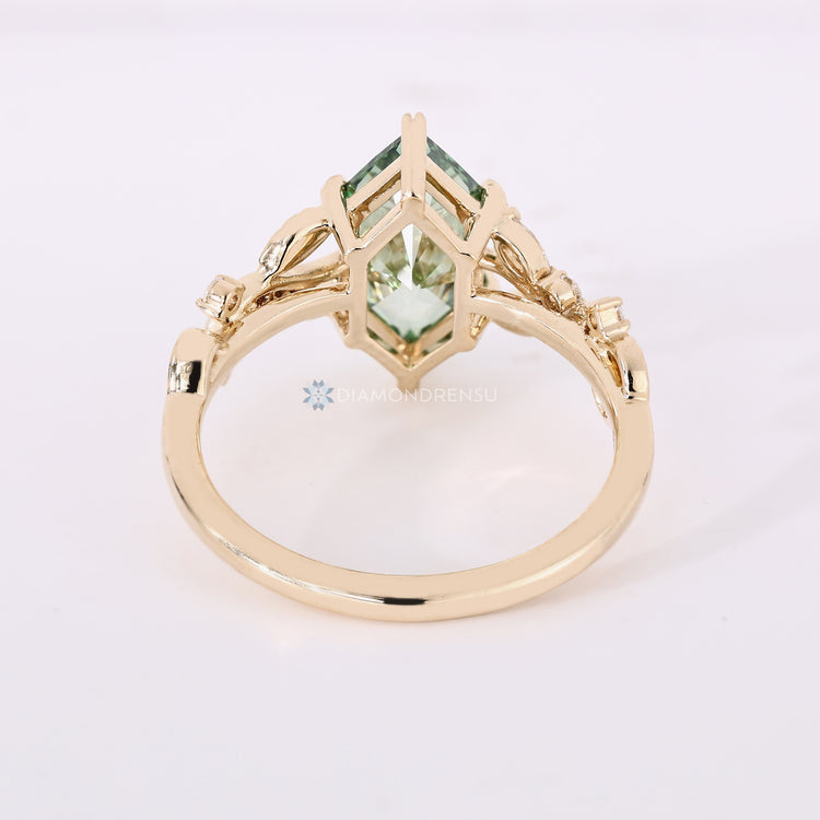 Dutch marquise diamond ring with leaf prongs and side stones.