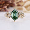 Hexagon diamond ring with green diamond.
