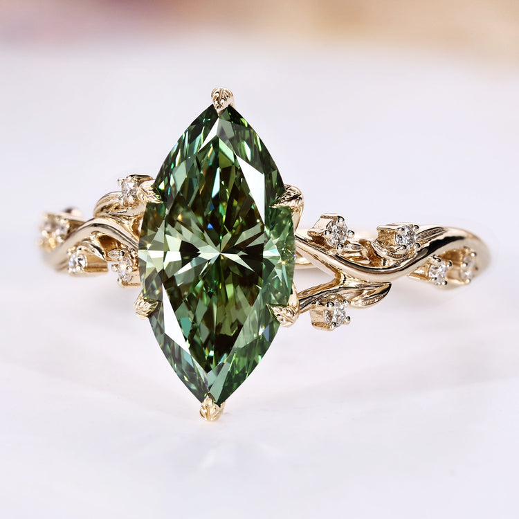 Marquise cut diamond ring with green diamond.