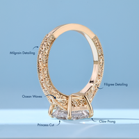 Princess cut diamond ring with four claw prongs.