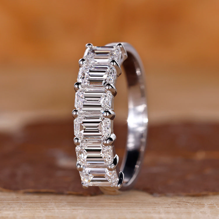 Emerald cut diamond wedding band six stone shared prong.
