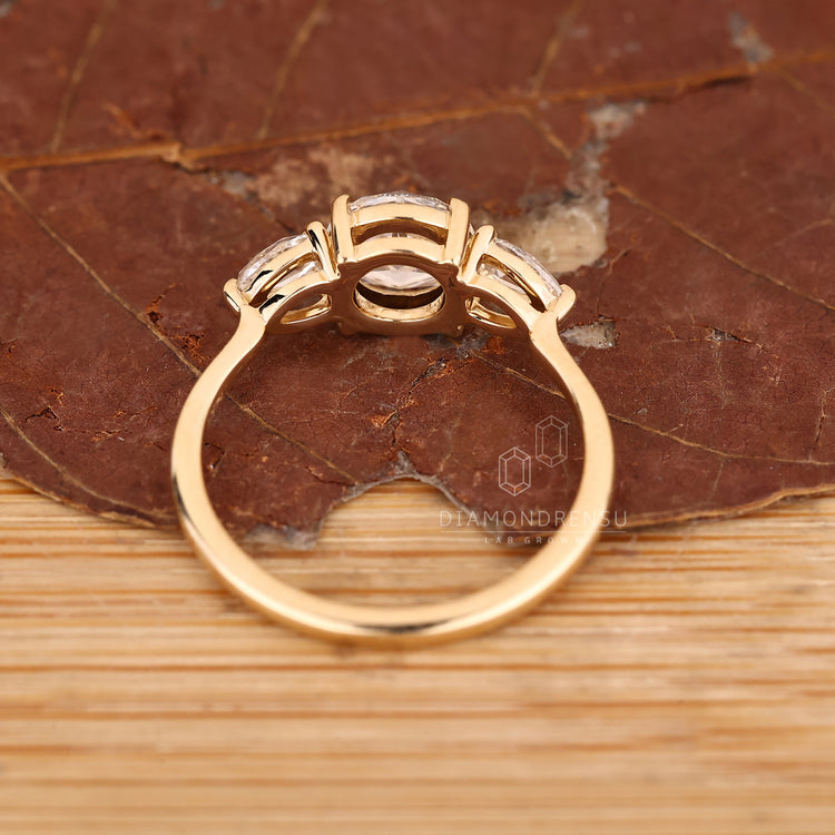 Round and pear rose cut diamond three stone style.
