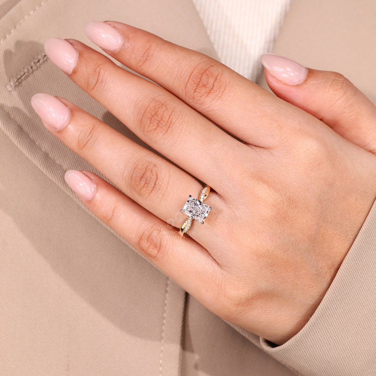 Radiant cut diamond ring with four claw prong setting.
