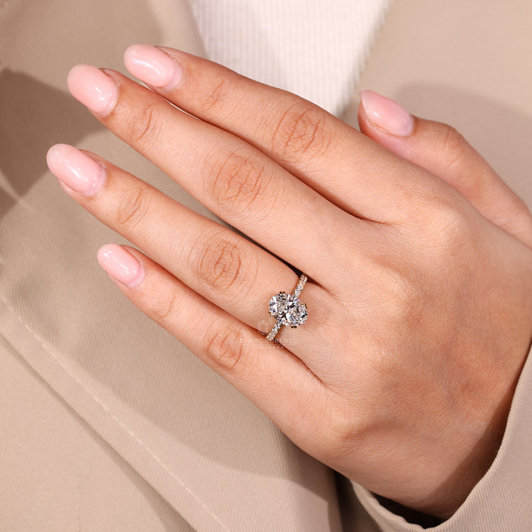 Hidden halo engagement ring with double claw prong setting.
