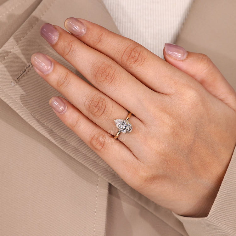 Hidden halo engagement ring with six leaf style prong.
