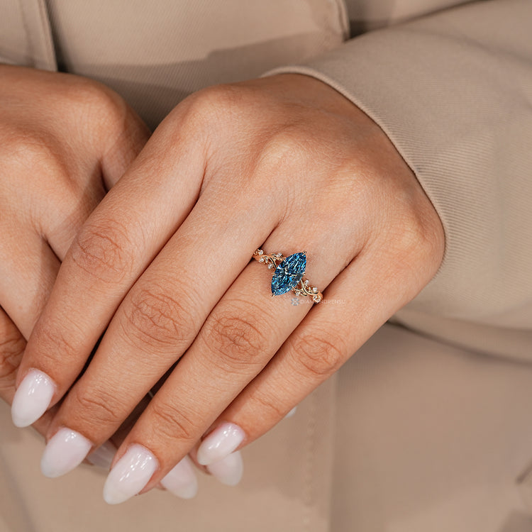 Marquise cut diamond ring with leaf prong details.