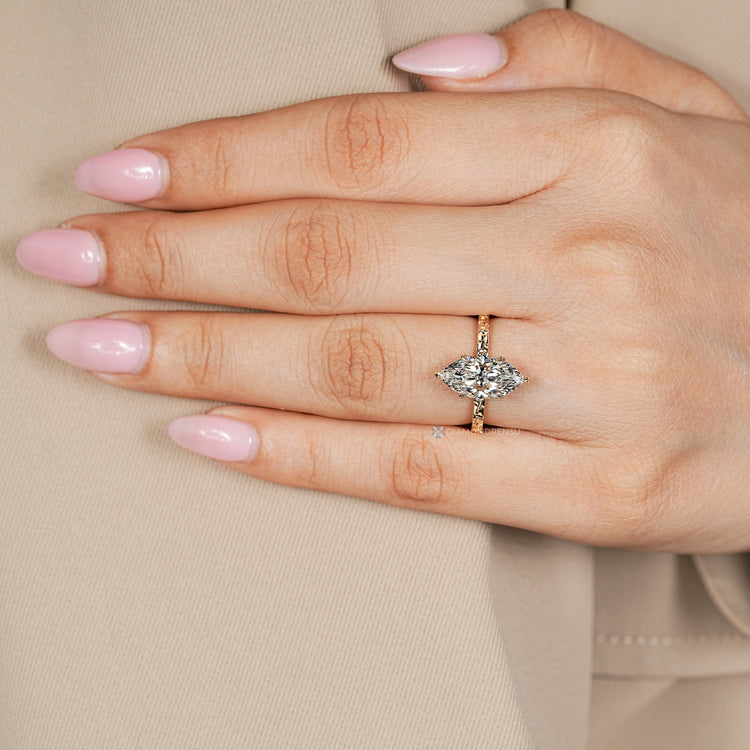 Marquise diamond ring with floral shank design.