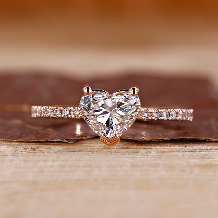 Heart cut diamond ring with round cut pave setting.
