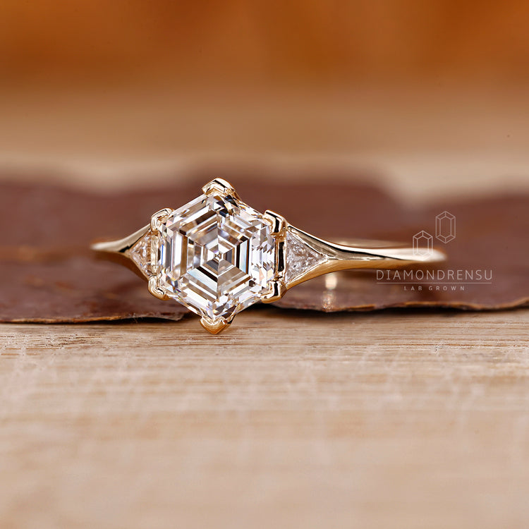 Hexagon diamond ring triangle side stones prong set.
