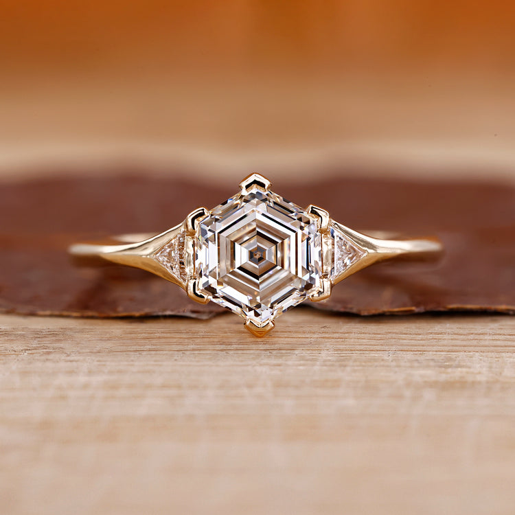 Hexagon step cut diamond ring triangle side stones.
