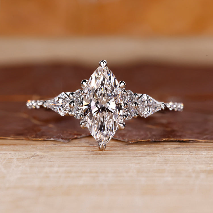 Marquise diamond ring kite round side stones muse set.
