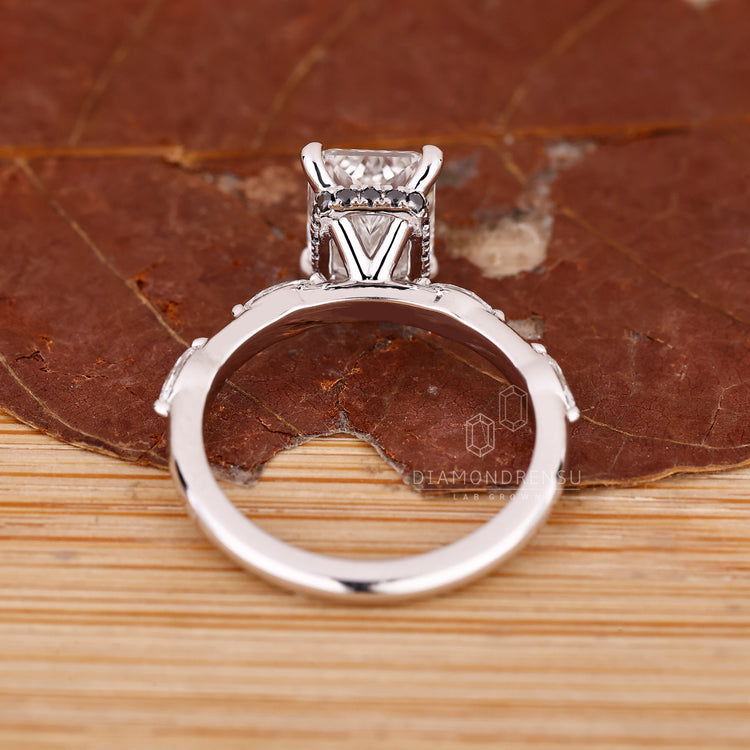 Hidden halo engagement ring with marquise and round side stones.