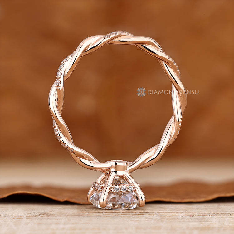 Portuguese diamond ring with twisted shank and halo.