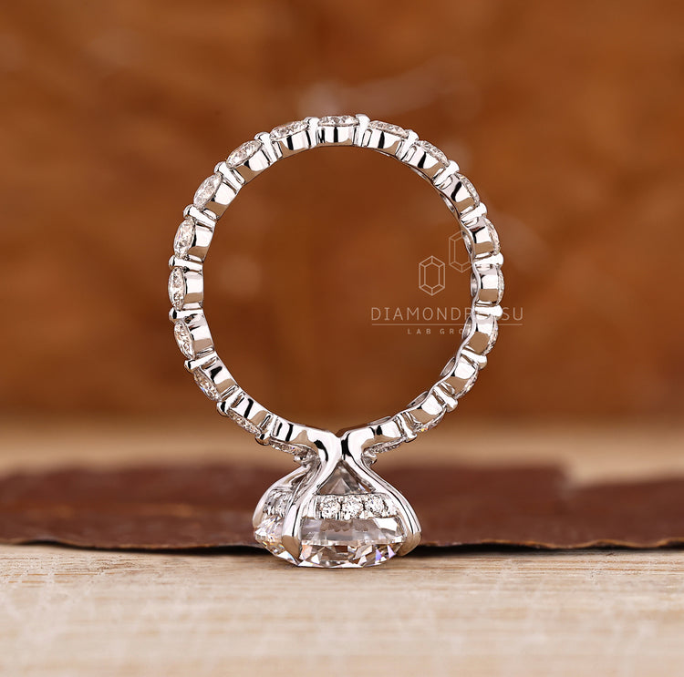Lab grown blue oval diamond ring with side hearts.
