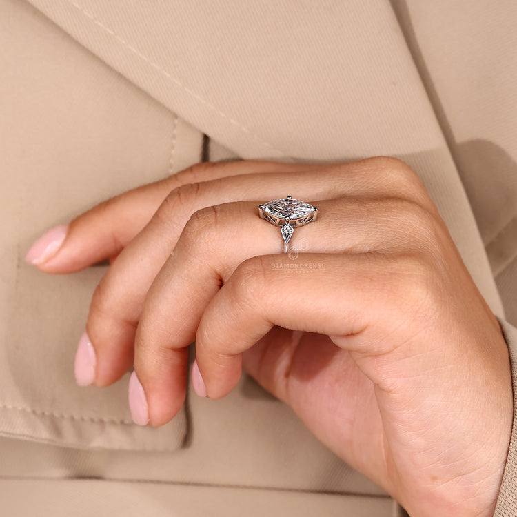Marquise diamond ring compass prong three stone.

