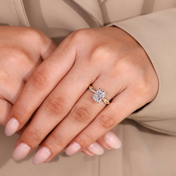 Twisted shank radiant cut diamond ring with pave band.
