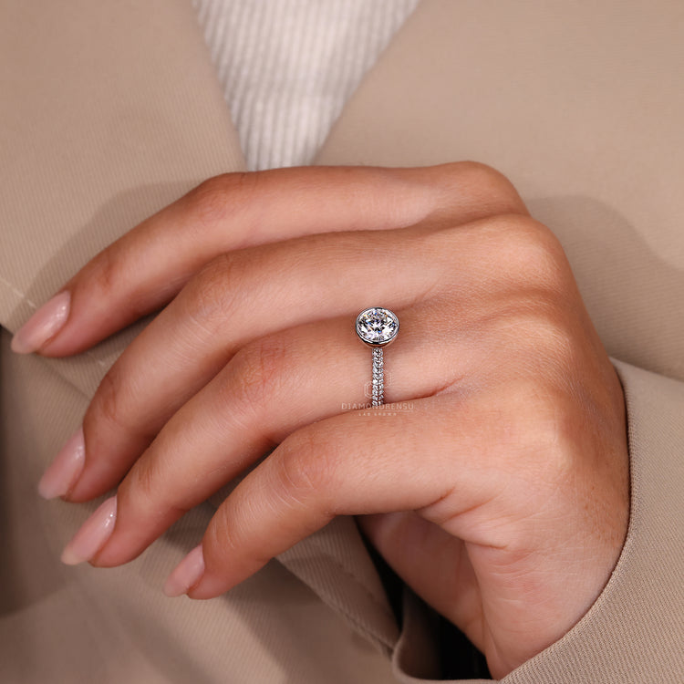 Cathedral setting round diamond bezel ring.
