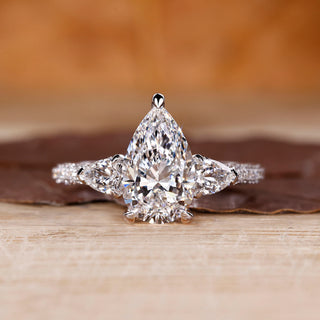 Cathedral diamond ring with pear cut centre stone.
