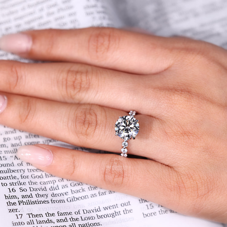 Three stone engagement ring with blue oval center stone.
