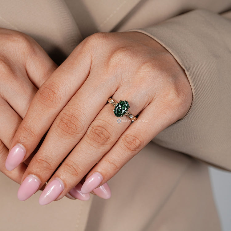 Oval diamond ring with milgrain and four claw prongs.