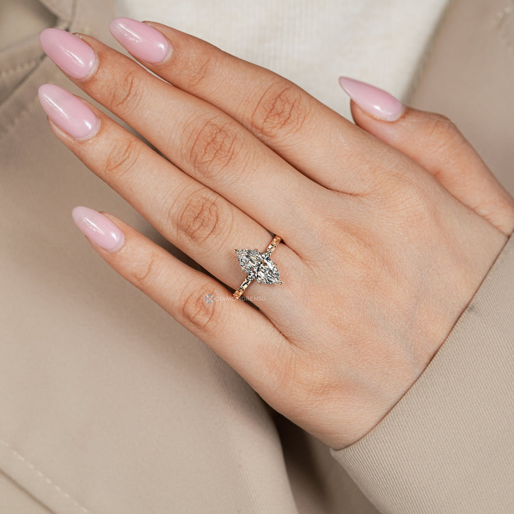 Nature inspired marquise ring with leaf prongs.