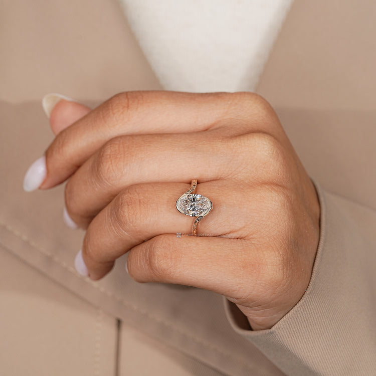 Oval cut diamond ring with vintage Art Deco details.