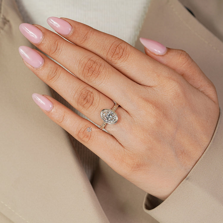Lab grown oval diamond ring with bezel setting.