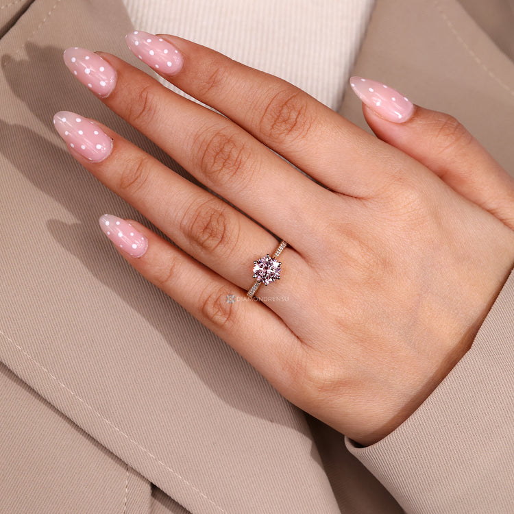 Pink diamond ring with cathedral setting.