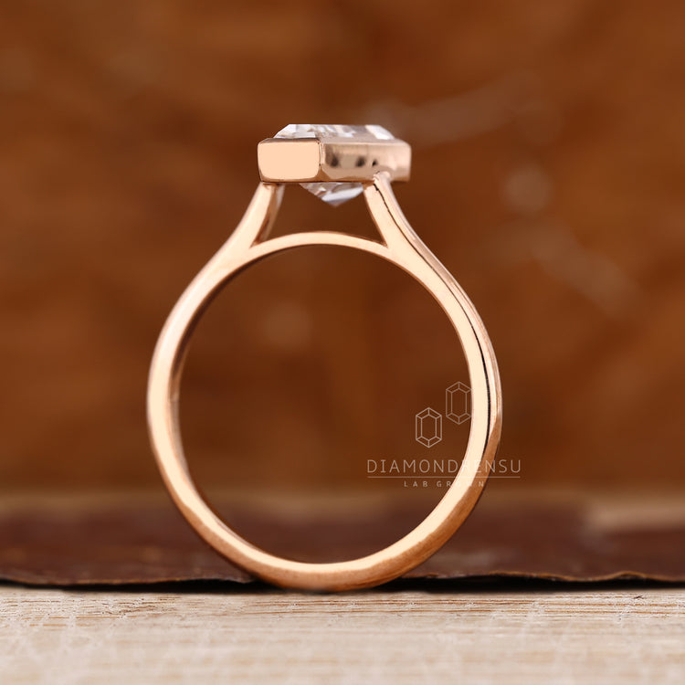 Coffin diamond ring bezel cathedral setting style.