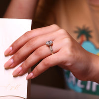 Marquise and round side stones in yellow gold engagement ring.
