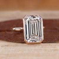 Solitaire diamond ring with emerald cut lab grown diamond.