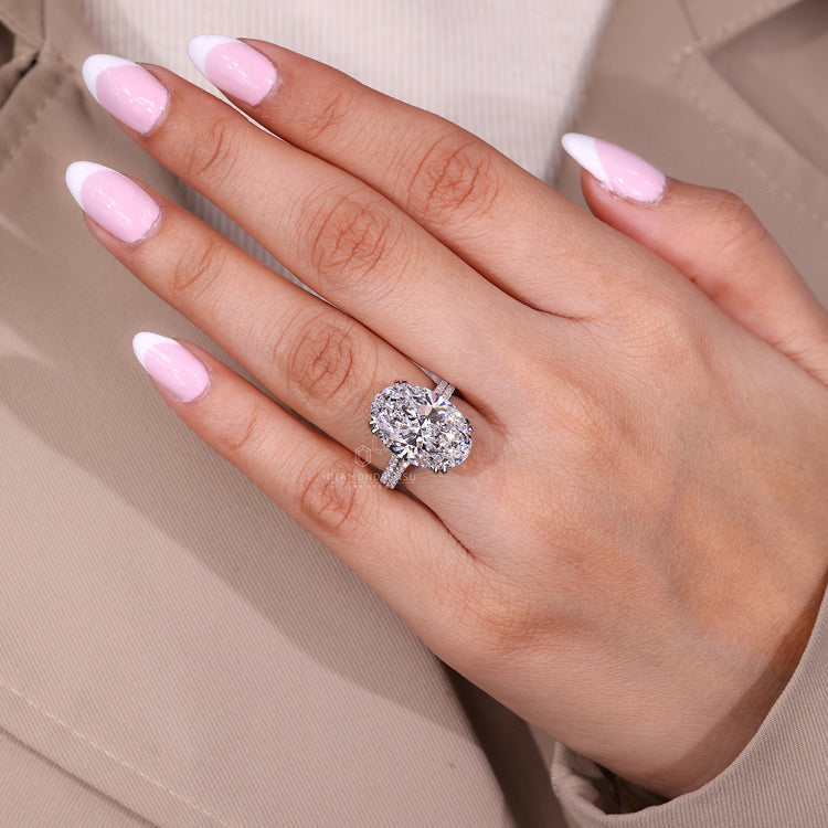 Custom diamond ring with oval centre and pave band.