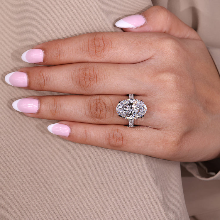 Handmade jewellery oval diamond ring with pave round diamonds.