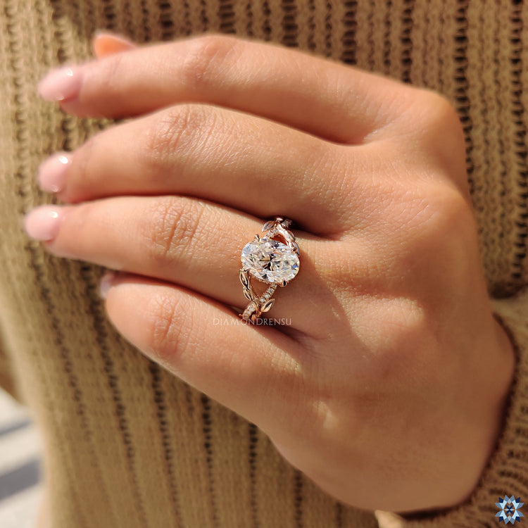 Oval moissanite ring features moissanite pave ring accents.
