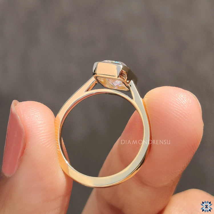 Handmade ring with Emerald cut solitaire diamond set in yellow gold.