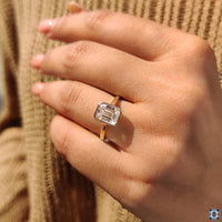 Solitaire engagement ring crafted in yellow gold with a Emerald cut.