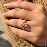Unique engagement ring with a Emerald cut diamond in yellow gold.