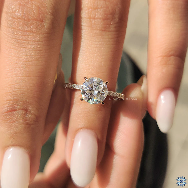 Unique engagement ring in yellow gold with fine pave and claw prong ring setting