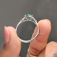 Cyan blue moissanite ring glows with bold and vivid colour.
