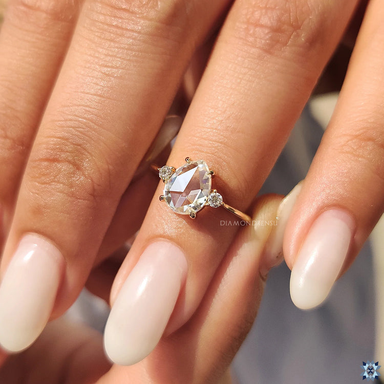 Handmade Jewelry: 3 Stone Engagement Ring with pear rose cut and a claw prong setting.
