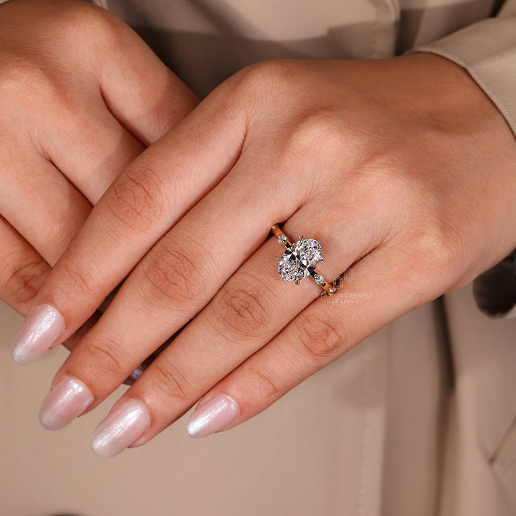 Round Side Stone Ring with distance pave diamond detailing.

