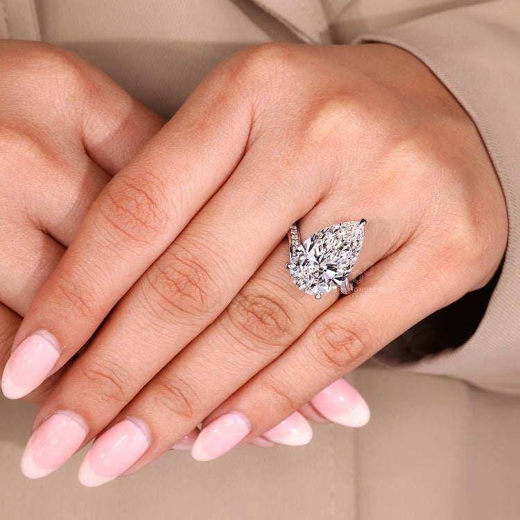 Handmade ring with pear cut diamond and double row pave.