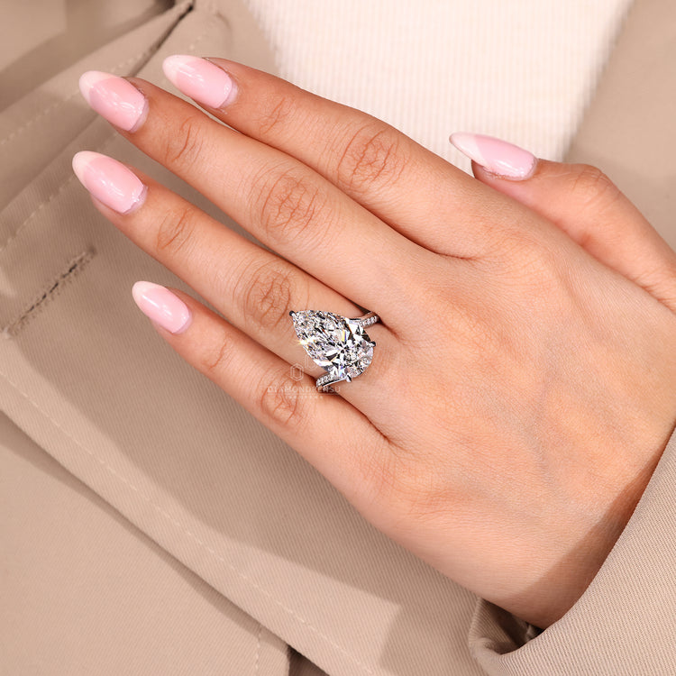 Diamondrensu AU ring with pear cut diamond and bypass setting.