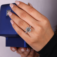 Pave round diamond ring with emerald cut centre.