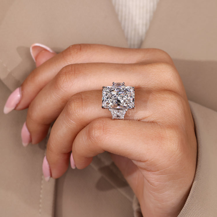 Cathedral setting ring featuring radiant cut diamond and trapezoid side stones.