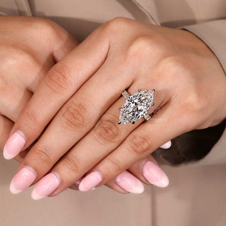 Handmade ring with marquise diamond and pave band.